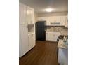 Well-lit kitchen features white cabinets, granite countertops, and stainless steel appliances at 2058 Pair Sw Rd, Marietta, GA 30008