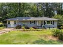 Well-maintained single-story home with gray paint and front yard landscaping at 553 Collingwood Dr, Decatur, GA 30032