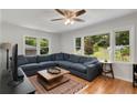 Bright living room featuring hardwood floors, large windows and a comfortable sectional sofa at 553 Collingwood Dr, Decatur, GA 30032