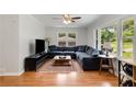 Cozy living room with hardwood floors, large windows, and a comfortable sectional sofa at 553 Collingwood Dr, Decatur, GA 30032