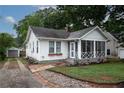 Quaint home with a screened porch, brick-and-stone driveway, and a detached garage at 3116 Jackson St, Hapeville, GA 30354