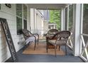 Relaxing screened porch featuring wicker furniture and a cozy atmosphere at 3116 Jackson St, Hapeville, GA 30354