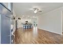 Open-concept living space with wood floors, natural light, and modern finishes, flowing seamlessly into the kitchen for easy living at 3891 Shelleydale Dr, Powder Springs, GA 30127