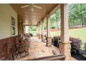 Spacious, covered front porch featuring stone columns, slate floor, and ample seating at 7131 Ridge Rd, Hiram, GA 30141