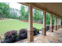 Inviting front porch with stone columns and lush landscaping at 7131 Ridge Rd, Hiram, GA 30141