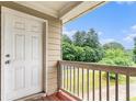 Outdoor balcony with wood railing and view of green landscaping at 2996 Jonesboro Road Southeast Se Rd # J, Atlanta, GA 30354