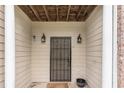 Covered entryway featuring a secure metal gate and decorative sconce lighting at 2996 Jonesboro Road Southeast Se Rd # J, Atlanta, GA 30354