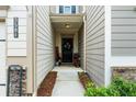 Inviting front porch with a black door, neutral siding, and decorative touches for added curb appeal at 3504 Castleberry Village Cir # 36, Cumming, GA 30040