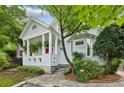 Charming home featuring a covered front porch, beautiful landscaping, and a quaint, historic design at 797 Ashland Ne Ave, Atlanta, GA 30307