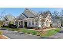 Charming townhouse with a covered porch, pretty landscaping, and beautiful lawn at 2565 Grapevine Cir # 103, Cumming, GA 30041