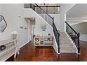 Grand foyer with hardwood floors, elegant staircase, and stylish decor at 290 Bluff Oak Dr, Roswell, GA 30076