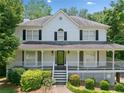 Beautiful white home featuring a classic design and covered porch at 308 Golden Ct, Canton, GA 30114