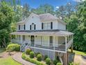 Inviting home with a spacious front porch and lush landscaping at 308 Golden Ct, Canton, GA 30114