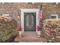 Elegant brick entryway featuring double iron doors and manicured landscaping at 335 S Satinwood Pl, Roswell, GA 30076