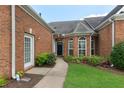 Close-up of entrance showcasing front door, walkway, and beautiful landscaping at 5250 Villa Lake Ct, Suwanee, GA 30024