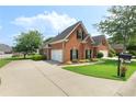 Charming brick home with attached two-car garage and well-manicured landscaping at 5250 Villa Lake Ct, Suwanee, GA 30024