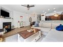 Open-concept living room featuring a fireplace, recessed lighting, and access to the kitchen at 771 Arbor Gate Ln, Lawrenceville, GA 30044