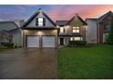 Attractive two-story home featuring a two-car garage, brick facade, and well-kept lawn at 773 Minor Oaks Nw Run, Lilburn, GA 30047