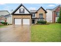 Attractive two-story home featuring a two-car garage, brick facade, and well-kept lawn at 773 Minor Oaks Nw Run, Lilburn, GA 30047