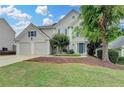 Lovely two-story home with mature trees, green lawn and a two-car garage at 12060 Carriage Park Ln, Duluth, GA 30097