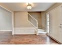 Bright foyer featuring hardwood floors, a staircase and a front door at 12060 Carriage Park Ln, Duluth, GA 30097