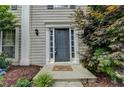 Charming front entrance with decorative door and well-manicured landscaping at 12060 Carriage Park Ln, Duluth, GA 30097