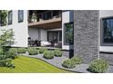 Inviting patio with stone detail, outdoor seating, and lush landscaping for relaxing and entertaining at 339 Peachtree Ne Ave, Atlanta, GA 30305