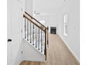 Bright entryway featuring wood-look floors and a staircase with decorative metal spindles at 2528 Morgan Chase Dr, Buford, GA 30519