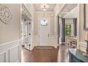 Inviting foyer with hardwood floors, elegant decor, and a view into the adjacent dining and living areas at 3352 Stone Point Way, Buford, GA 30519