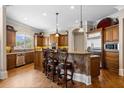 Spacious kitchen featuring a large island with seating, stainless steel appliances, and custom cabinetry at 8295 St Marlo Fairway Dr, Duluth, GA 30097