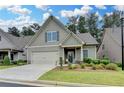Charming, single-story home boasts a manicured lawn, attached garage and welcoming front porch at 3112 Patriot Sw Sq, Marietta, GA 30064