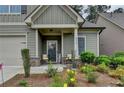 Cozy front porch features stone accents, a welcoming entrance and charming seating area at 3112 Patriot Sw Sq, Marietta, GA 30064