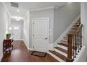 Bright entry hallway featuring hardwood floors, staircase, and neutral paint at 3112 Patriot Sw Sq, Marietta, GA 30064