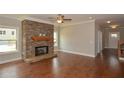 Cozy living room with a stone fireplace and hardwood floors at 3112 Patriot Sw Sq, Marietta, GA 30064
