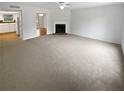 Spacious living room with neutral carpet, fireplace, and views of kitchen. (Not staged) at 688 Anderson Walk, Marietta, GA 30062