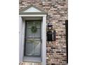 Close up of front door with elegant trim, classic wreath and modern black mailbox with house numbers at 2435 Northlake Ct, Atlanta, GA 30345