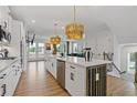 Bright, white kitchen with large center island, stainless appliances and hardwood floors at 2808 Maddison Towns Ave, Norcross, GA 30071