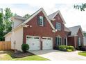 Charming two-story brick home with a two-car garage, manicured lawn, and beautiful landscaping at 4046 Creekview Ridge Dr, Buford, GA 30518