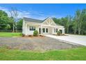 Beautiful single-story home showcasing a white exterior, well-manicured lawn, and a modern design at 4824 Se Highway 20, Conyers, GA 30013
