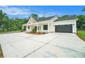 Lovely modern farmhouse with a covered porch and a wide driveway leading to an attached garage at 4824 Se Highway 20, Conyers, GA 30013