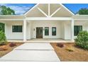 Inviting front porch with craftsman columns, a double door entry, and manicured landscaping at 4824 Se Highway 20, Conyers, GA 30013