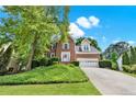 Traditional two-story brick home with a well manicured lawn and established landscaping at 230 Channings Lake Dr, Lawrenceville, GA 30043