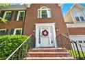 Close up of the brick steps and welcoming front door adorned with a wreath at 230 Channings Lake Dr, Lawrenceville, GA 30043