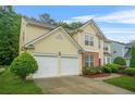 Charming two-story home featuring a manicured lawn and a two car garage at 606 Hay Meadow, Acworth, GA 30102