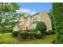 Charming two-story home featuring a red door, manicured lawn and a two car garage at 606 Hay Meadow, Acworth, GA 30102