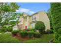 Charming two-story home featuring a red door, manicured lawn and a two car garage at 606 Hay Meadow, Acworth, GA 30102