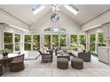 Bright and airy sunroom with vaulted ceilings, skylights, and a wall of windows overlooking the landscaped yard at 965 Heards Ferry Rd, Sandy Springs, GA 30328