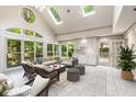 Bright and airy sunroom with vaulted ceilings, skylights, and a wall of windows overlooking the landscaped yard at 965 Heards Ferry Rd, Sandy Springs, GA 30328