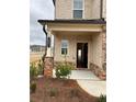 A close-up of a home's entrance featuring a column, brickwork and the house number at 1001 Limburg Dr, Hampton, GA 30228