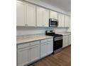 A kitchen featuring stainless steel appliances, including a microwave and a gas range at 1001 Limburg Dr, Hampton, GA 30228